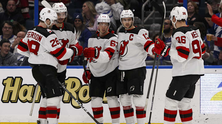 Mar 19, 2023; Tampa, Florida, USA; New Jersey Devils left wing Jesper Brett (63) celebrates with defenseman Damon Severs (28), center Nico Hischier (13), right wing Timo Meier (96) and defenseman Kevin Bahl (88) after a goal during the second period at Amalie Arena. Mandatory Credit: Morgan Tencza-Imagn Images