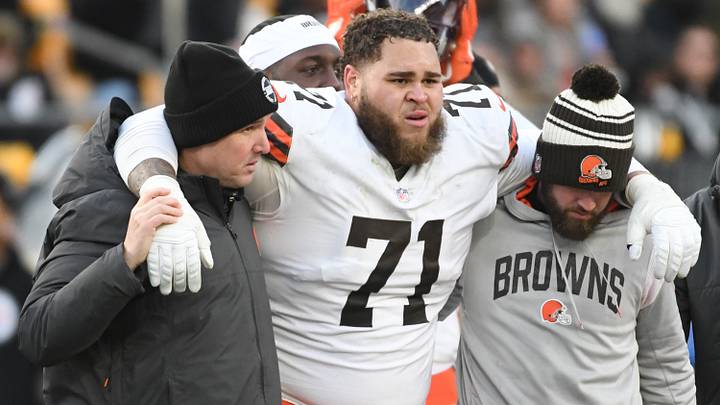 Jan 8, 2023; Pittsburgh, Pennsylvania, USA;  Injured Cleveland Browns tackle Jedrick Wills Jr. (71) is helped off the field in a game against the Pittsburgh Steelers during the fourth quarter at Acrisure Stadium.