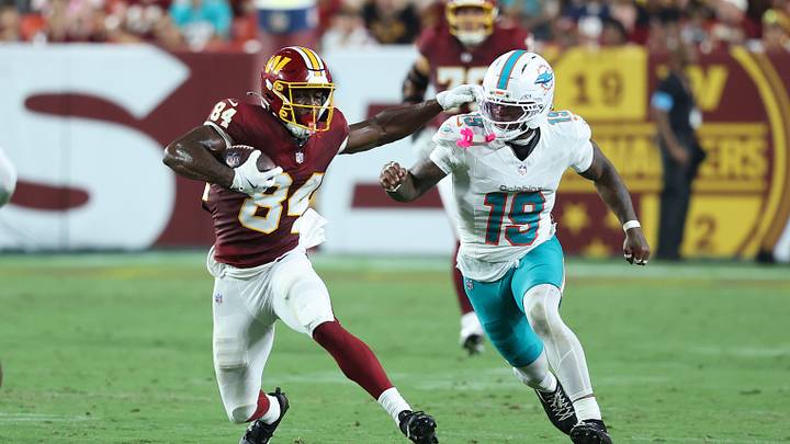 Washington Commanders wide receiver Jacoby Jones (84) runs with the ball as Miami Dolphins linebacker Kyle Louis (19) defends during the second half at Northwest Stadium. Washington Commanders wide receiver Jacoby Jones (84) runs with the ball as Miami Dolphins linebacker Kyle Louis (19) defends during the second half at Northwest Stadium.