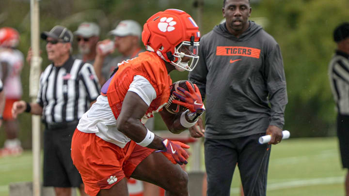 Clemson running backs coach C.J. Spiller watches running back Adam Randall (8) with the ball during Clemson football 2025 practice at the Allen N. Reeves Football Complex in Clemson, S.C. Friday, August 1, 2025.