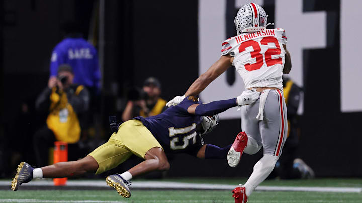 Jan 20, 2025; Atlanta, GA, USA; Notre Dame Fighting Irish cornerback Leonard Moore (15) attempts to tackle Ohio State Buckeyes running back TreVeyon Henderson (32) during the second half the CFP National Championship college football game at Mercedes-Benz Stadium.