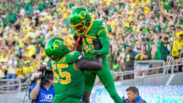 Oregon Ducks offensive lineman Marcus Harper II lifts Oregon Ducks wide receiver Tez Johnson into the air after a touchdown as the Oregon Ducks host the Idaho Vandals Saturday, Aug. 31, 2024 at Autzen Stadium in Eugene, Ore.