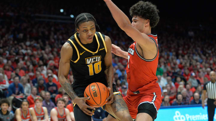 Mar 8, 2024; Dayton, Ohio, USA;  Virginia Commonwealth Rams forward Toibu \"Tobi\" Lawal (10) battles against Dayton Flyers forward Nate Santos (2) during the first half of the game at University of Dayton Arena. Mandatory Credit: Matt Lunsford-USA TODAY Sports