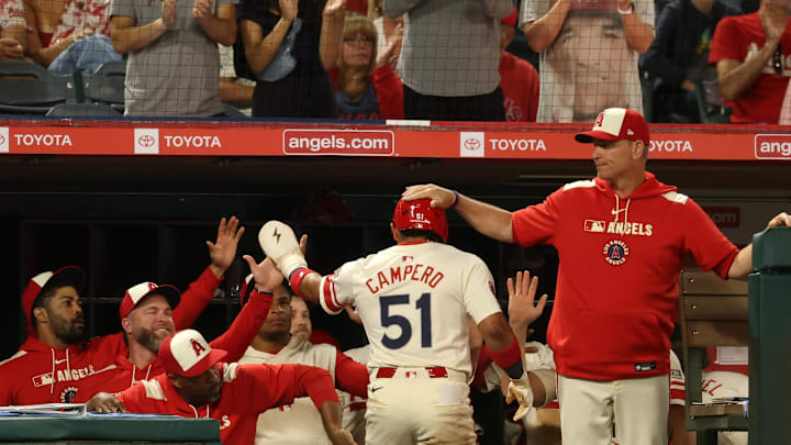 Jul 29, 2025; Anaheim, California, USA; Los Angeles Angels right fielder Gustavo Campero (51) is greeted by interim manager Ray Montgomery (81, right) after scoring a run during the sixth inning against the Texas Rangers at Angel Stadium. Mandatory Credit: Kiyoshi Mio-Imagn Images Jul 29, 2025; Anaheim, California, USA; Los Angeles Angels right fielder Gustavo Campero (51) is greeted by interim manager Ray Montgomery (81, right) after scoring a run during the sixth inning against the Texas Rangers at Angel Stadium. Mandatory Credit: Kiyoshi Mio-Imagn Images