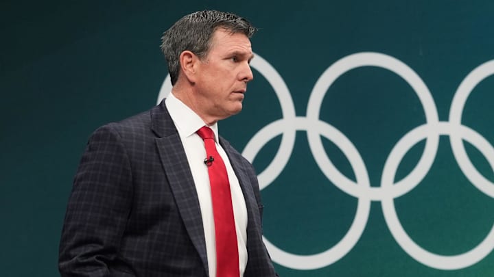 Feb 22, 2026; Milan, Italy; Mike Sullivan head coach of the United States walks to the ice before playing Canada in the men's ice hockey gold medal game during the Milano Cortina 2026 Olympic Winter Games at Milano Santagiulia Ice Hockey Arena. Mandatory Credit: Amber Searls-Imagn Images