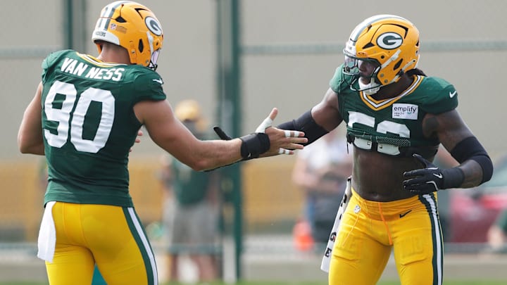 Green Bay Packers defensive linemen Lukas Van Ness (90) and Rashan Gary (52) interact during practice on Aug. 5, 2025, at Ray Nitschke Field in Ashwaubenon, Wis.