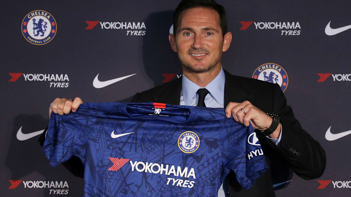 Former Chelsea manager Frank Lampard holds up the team jersey.
