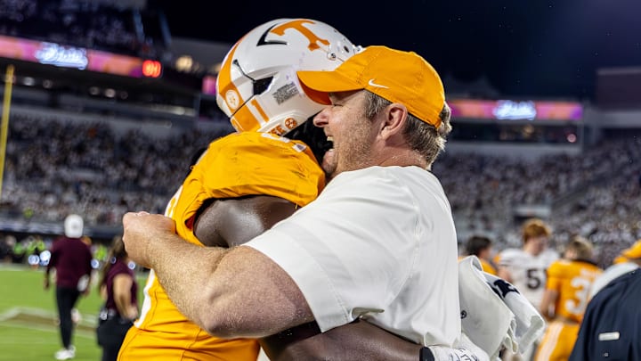 Sep 27, 2025; Starkville, Mississippi, USA; Tennessee Volunteers head coach Josh Heupel and defensive lineman Caleb Herring (31) celebrate after winning the game against the Mississippi State Bulldogs at Davis Wade Stadium at Scott Field. Mandatory Credit: Wesley Hale-Imagn Images