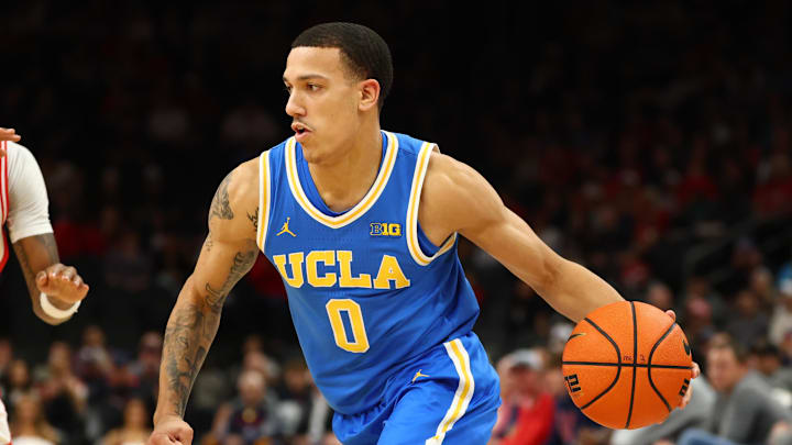Dec 14, 2024; Phoenix, Arizona, USA; UCLA Bruins guard Kobe Johnson (0) against the Arizona Wildcats at Footprint Center. Mandatory Credit: Mark J. Rebilas-Imagn Images