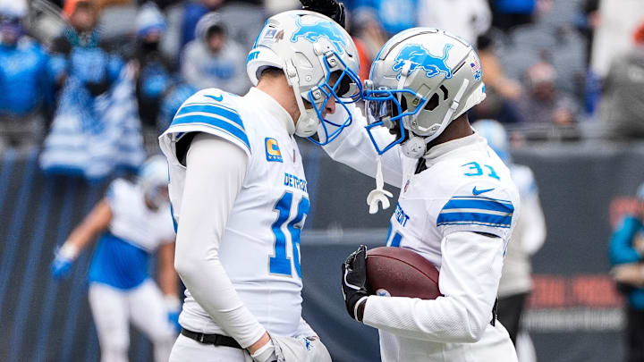 Detroit Lions quarterback Jared Goff (16), left, hugs safety Kerby Joseph (31) at warm up before the game between Chicago Bears and Detroit Lions at Soldier Field in Chicago, Ill. on Sunday, Dec. 22, 2024.