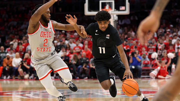 Jan 3, 2025; Columbus, Ohio, USA;  Michigan State Spartans guard Jase Richardson (11) dribbles past Ohio State Buckeyes guard Bruce Thornton (2) during the first half at Value City Arena. Mandatory Credit: Joseph Maiorana-Imagn Images