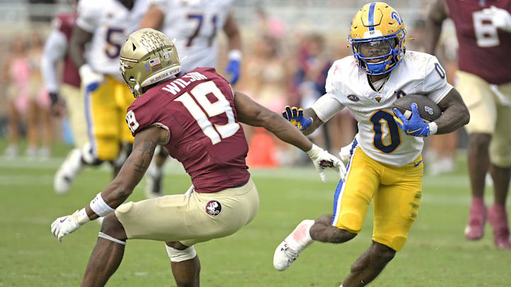 Oct 11, 2025; Tallahassee, Florida, USA; Pittsburgh Panthers running back Desmond Reid (0) runs the ball past Florida State Seminoles defensive back Jerry Wilson (19) during the second half at Doak S. Campbell Stadium. Mandatory Credit: Melina Myers-Imagn Images