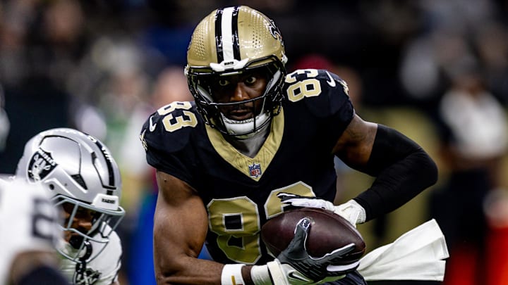 Dec 29, 2024; New Orleans, Louisiana, USA;  New Orleans Saints tight end Juwan Johnson (83) catches a pass against the Las Vegas Raiders during the first half at Caesars Superdome. Mandatory Credit: Stephen Lew-Imagn Images