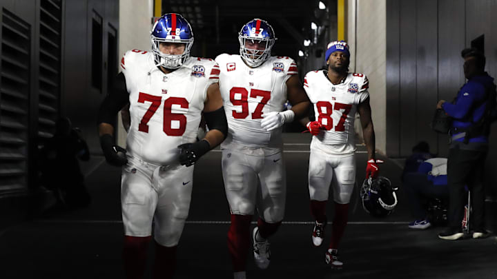 Oct 28, 2024; Pittsburgh, Pennsylvania, USA;  New York Giants guard Jon Runyan (76), defensive tackle Dexter Lawrence II (97), and wide receiver Ihmir Smith-Marsette (87) take the field against the Pittsburgh Steelers at Acrisure Stadium. Mandatory Credit: Charles LeClaire-Imagn Images