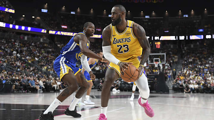 Oct 15, 2024; Las Vegas, Nevada, USA; Los Angeles Lakers forward LeBron James (23) dribbles past Golden State Warriors forward Jonathan Kuminga (00) in the third quarter during a preseason game at T-Mobile Arena. Mandatory Credit: Candice Ward-Imagn Images