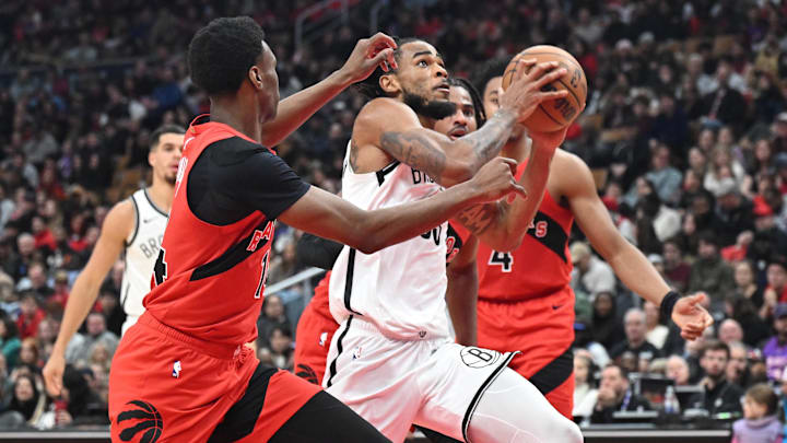 Nov 23, 2025; Toronto, Ontario, CAN;  Brooklyn Nets center Nic Claxton (33) drives to the basket against the Toronto Raptors in the first half at Scotiabank Arena. Mandatory Credit: Dan Hamilton-Imagn Images