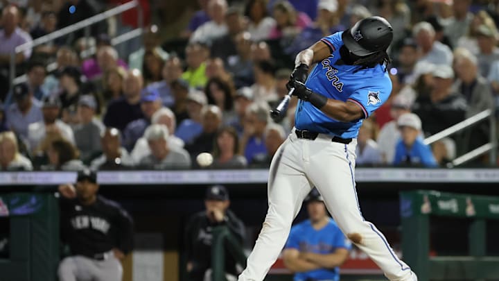 Mar 4, 2024; Jupiter, Florida, USA; Miami Marlins first baseman Josh Bell (9) hits an RBI double