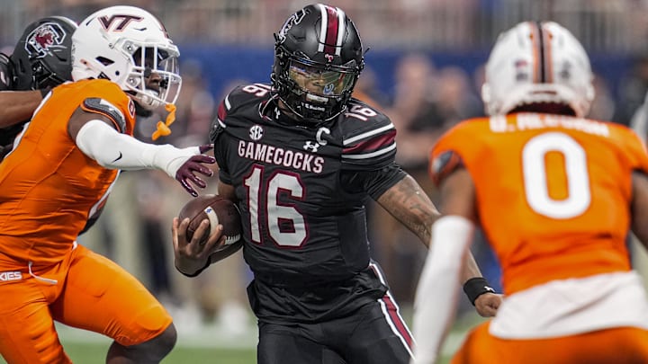 Aug 31, 2025; Atlanta, Georgia, USA; South Carolina Gamecocks quarterback LaNorris Sellers (16) runs against Virginia Tech Hokies safety Quentin Reddish (0) during the first half at Mercedes-Benz Stadium. Mandatory Credit: Dale Zanine-Imagn Images