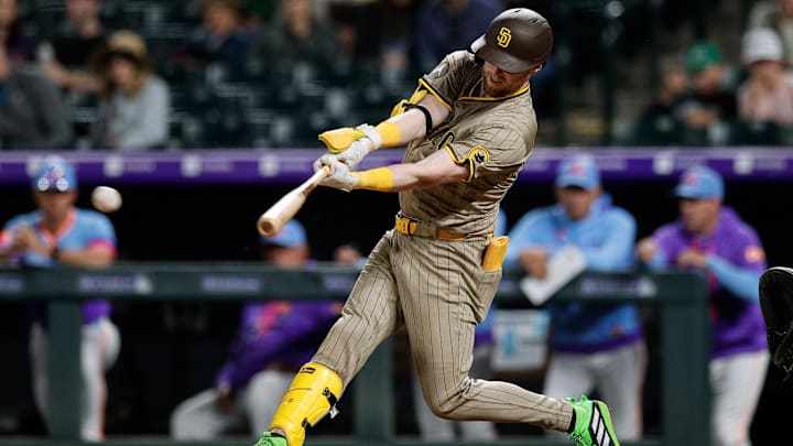 May 9, 2025; Denver, Colorado, USA; San Diego Padres second baseman Jake Cronenworth (9) hits an RBI single in the eighth inning against the Colorado Rockies at Coors Field. Mandatory Credit: Isaiah J. Downing-Imagn Images