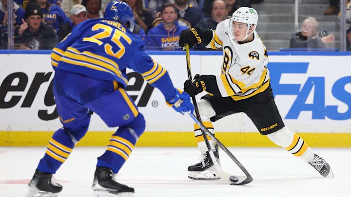 Apr 19, 2026; Buffalo, New York, USA; Buffalo Sabres defenseman Owen Power (25) tries to block a shot by Boston Bruins center James Hagens (44) during the third period in game one of the first round of the 2026 Stanley Cup Playoffs at KeyBank Center. Mandatory Credit: Timothy T. Ludwig-Imagn Images