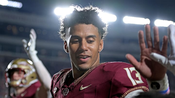Nov 11, 2023; Tallahassee, Florida, USA; Florida State Seminoles quarterback Jordan Travis (13) high fives a young fan after winning the game against the Miami Hurricanes at Doak S. Campbell Stadium. Mandatory Credit: Melina Myers-Imagn Images Nov 11, 2023; Tallahassee, Florida, USA; Florida State Seminoles quarterback Jordan Travis (13) high fives a young fan after winning the game against the Miami Hurricanes at Doak S. Campbell Stadium. Mandatory Credit: Melina Myers-Imagn Images