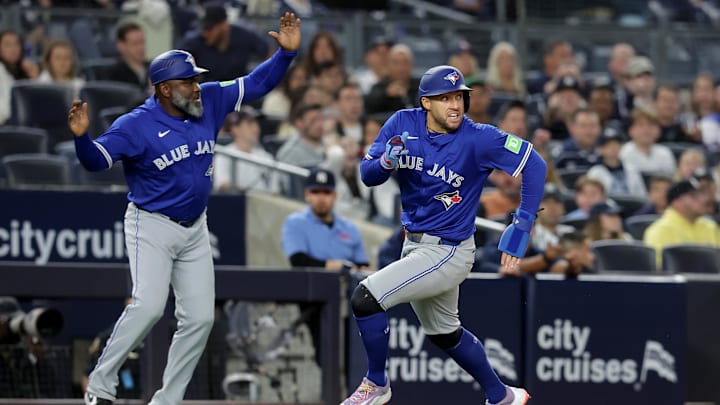 Apr 25, 2025: Toronto Blue Jays center fielder George Springer (4) rounds third base as third base coach Carlos Febles (51) waves him around to score on an RBI double by catcher Alejandro Kirk (not pictured) during the ninth inning against the New York Yankees at Yankee Stadium. 