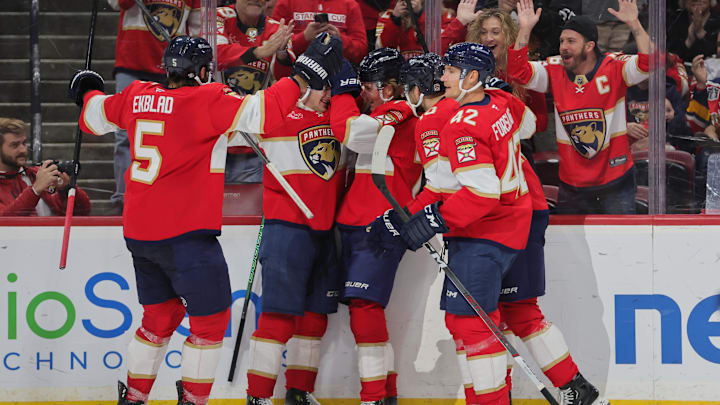 Oct 17, 2024; Sunrise, Florida, USA; Florida Panthers center Jesper Boqvist (70) celebrates with teammates after scoring against the Vancouver Canucks during the first period at Amerant Bank Arena. Mandatory Credit: Sam Navarro-Imagn Images