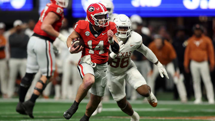Dec 7, 2024; Atlanta, GA, USA; Georgia Bulldogs quarterback Gunner Stockton (14) rushes the ball against the Texas Longhorns during the second half in the 2024 SEC Championship game at Mercedes-Benz Stadium. Mandatory Credit: Brett Davis-Imagn Images