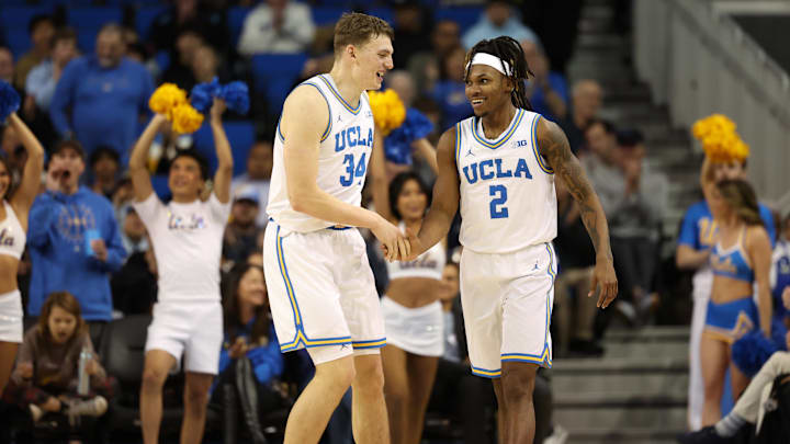 Jan 21, 2025; Los Angeles, California, USA;  UCLA Bruins guard Dylan Andrews (2) is greeted by forward Tyler Bilodeau (34) during the second half against the Wisconsin Badgers at Pauley Pavilion presented by Wescom. Mandatory Credit: Kiyoshi Mio-Imagn Images