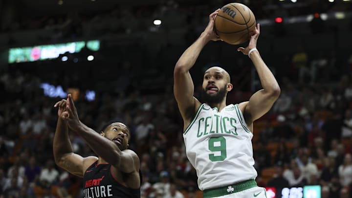 Jan 25, 2024; Miami, Florida, USA; Boston Celtics guard Derrick White (9) grabs a rebound against Miami Heat forward Haywood Highsmith (24) during the first quarter at Kaseya Center. Mandatory Credit: Sam Navarro-Imagn Images