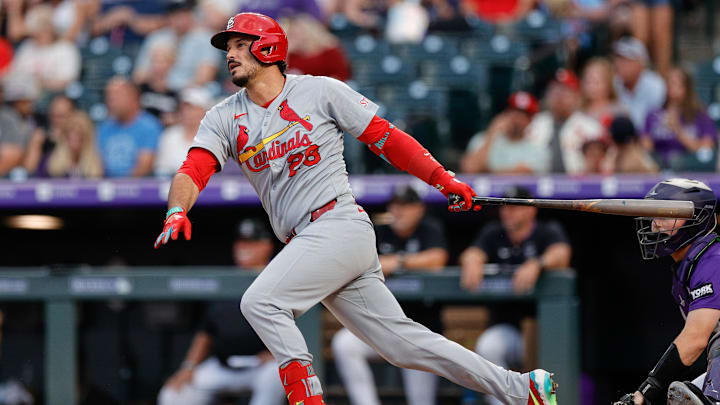 Jul 21, 2025; Denver, Colorado, USA; St. Louis Cardinals third baseman Nolan Arenado (28) hits a single in the sixth inning against the Colorado Rockies at Coors Field. Mandatory Credit: Isaiah J. Downing-Imagn Images