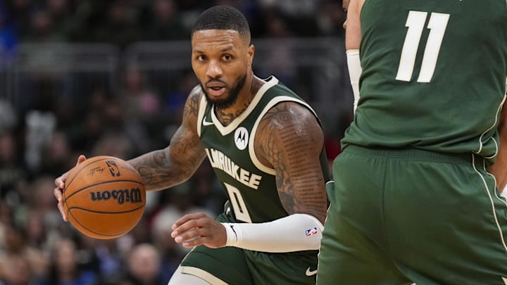Nov 18, 2024; Milwaukee, Wisconsin, USA;  Milwaukee Bucks guard Damian Lillard (0) drives towards the basket around center Brook Lopez (11) during the fourth quarter against the Houston Rockets at Fiserv Forum. Mandatory Credit: Jeff Hanisch-Imagn Images