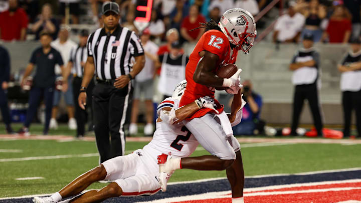 Aug 31, 2024; Tucson, Arizona, USA; Arizona Wildcats defensive back Treydan Stukes (2) fails to tackle before New Mexico Lobos wide receiver Caleb Medford (12) scores a touchdown during fourth quarter at Arizona Stadium. Mandatory Credit: Aryanna Frank-Imagn Images