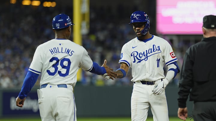 Oct 10, 2024; Kansas City, Missouri, USA;  Kansas City Royals third baseman Maikel Garcia (11) high-fives Kansas City Royals first base coach Damon Hollins (39) during the sixth inning following a bench clearing against the New York Yankees during game four of the ALDS for the 2024 MLB Playoffs at Kauffman Stadium. Mandatory Credit: Jay Biggerstaff-Imagn Images