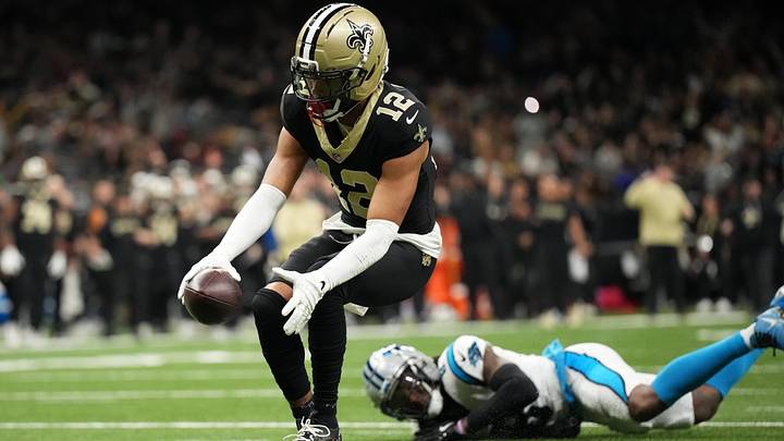 Dec. 14, 2025; New Orleans, Louisiana, USA; New Orleans Saints wide receiver Chris Olave (12) scores a touchdown against Carolina Panthers CB Jaycee Horn (8) at Caesars Superdome. Mandatory Credit: Matthew Hinton-Imagn Images