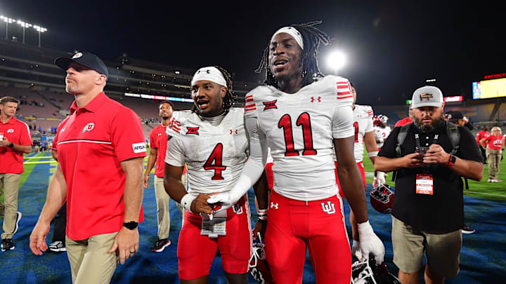 Utah Utes quarterback Devon Dampier (4) and cornerback Rock Caldwell (11) celebrate the victory against the UCLA Bruins at Rose Bowl.