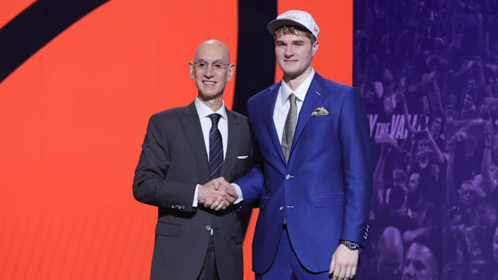 Jun 25, 2025; Brooklyn, NY, USA; Liam McNeeley stands with NBA commissioner Adam Silver after being selected as the 29th pick by the Phoenix Suns in the first round of the 2025 NBA Draft at Barclays Center. Mandatory Credit: Brad Penner-Imagn Images Jun 25, 2025; Brooklyn, NY, USA; Liam McNeeley stands with NBA commissioner Adam Silver after being selected as the 29th pick by the Phoenix Suns in the first round of the 2025 NBA Draft at Barclays Center. Mandatory Credit: Brad Penner-Imagn Images