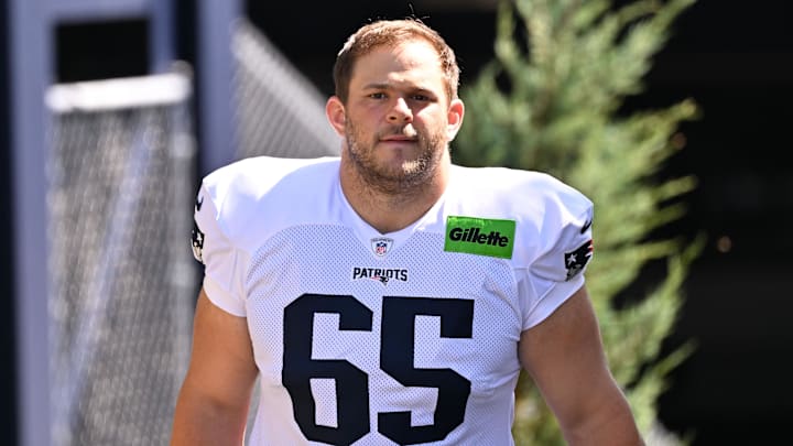 Jul 28, 2025; Foxborough, MA, USA; New England Patriots center Garrett Bradbury (65) heads to the practice fields for training camp at Gillette Stadium. Mandatory Credit: Eric Canha-Imagn Images
