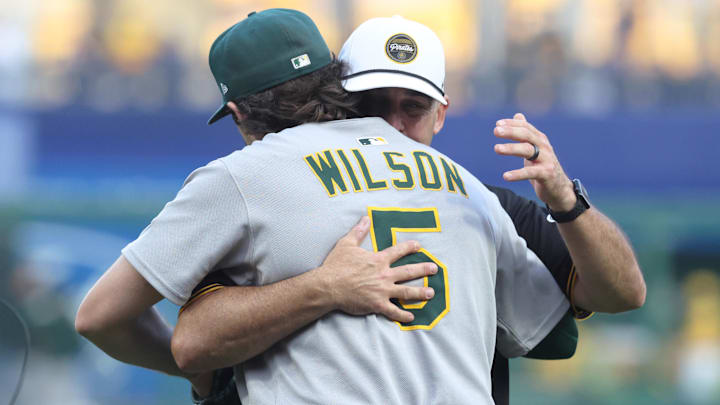 Sep 19, 2025; Pittsburgh, Pennsylvania, USA; Pittsburgh Pirates former shortstop Jack Wilson rear) embraces his son Athletics shortstop Jacob Wilson (5) after both took part in a ceremonial first pitch before the Pirates host the Athletics at PNC Park. Mandatory Credit: Charles LeClaire-Imagn Images Sep 19, 2025; Pittsburgh, Pennsylvania, USA; Pittsburgh Pirates former shortstop Jack Wilson rear) embraces his son Athletics shortstop Jacob Wilson (5) after both took part in a ceremonial first pitch before the Pirates host the Athletics at PNC Park. Mandatory Credit: Charles LeClaire-Imagn Images