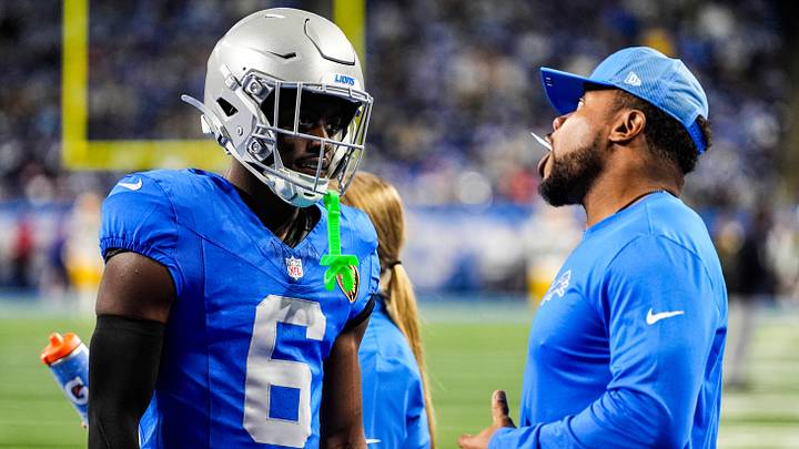 Detroit Lions cornerback Terrion Arnold (6) talks to running backs coach Tashard Rice at warmup ahead of the Green Bay Packers game at Ford Field in Detroit on Thursday, Nov. 27, 2025.