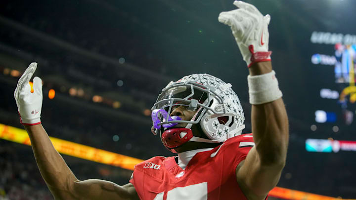 Ohio State Buckeyes wide receiver Carnell Tate (17) celebrates a touchdown Saturday, Dec. 6, 2025, during the Big Ten football championship against the Indiana Hoosiers at Lucas Oil Stadium in Indianapolis. Ohio State Buckeyes wide receiver Carnell Tate (17) celebrates a touchdown Saturday, Dec. 6, 2025, during the Big Ten football championship against the Indiana Hoosiers at Lucas Oil Stadium in Indianapolis.