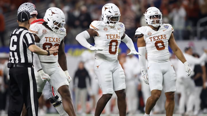 Jan 10, 2025; Arlington, Texas, USA; Texas Longhorns linebacker Anthony Hill Jr. (0) celebrates with linebacker Barryn Sorrell (88) and linebacker Trey Moore (8) after a play during the second quarter of the College Football Playoff semifinal against the Ohio State Buckeyes in the Cotton Bowl at AT&T Stadium. Mandatory Credit: Tim Heitman-Imagn Images Jan 10, 2025; Arlington, Texas, USA; Texas Longhorns linebacker Anthony Hill Jr. (0) celebrates with linebacker Barryn Sorrell (88) and linebacker Trey Moore (8) after a play during the second quarter of the College Football Playoff semifinal against the Ohio State Buckeyes in the Cotton Bowl at AT&T Stadium. Mandatory Credit: Tim Heitman-Imagn Images