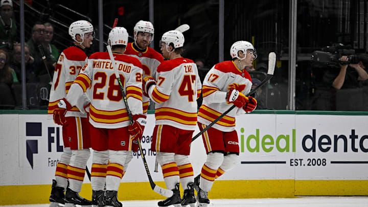 Apr 7, 2026; Dallas, Texas, USA; Calgary Flames defenseman Yan Kuznetsov (37) and defenseman Zach Whitecloud (28) and center Connor Zary (47) and center Yegor Sharangovich (17) celebrates a goal scored by Sharangovich against the Dallas Stars during the second period at the American Airlines Center. Mandatory Credit: Jerome Miron-Imagn Images