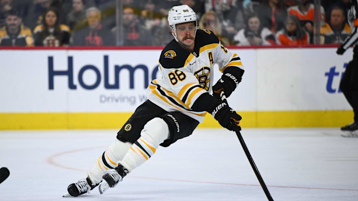 Nov 2, 2024; Philadelphia, Pennsylvania, USA; Boston Bruins right wing David Pastrnak (88) reaches for the puck against the Philadelphia Flyers in the second period at Wells Fargo Center. Mandatory Credit: Kyle Ross-Imagn Images