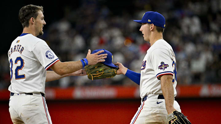 Mar 31, 2024; Arlington, Texas, USA; Texas Rangers left fielder Wyatt Langford (36) hands right fielder Evan Carter (32) his glove and hat during the game against the Chicago Cubs at Globe Life Field. Mandatory Credit: Jerome Miron-Imagn Images Mar 31, 2024; Arlington, Texas, USA; Texas Rangers left fielder Wyatt Langford (36) hands right fielder Evan Carter (32) his glove and hat during the game against the Chicago Cubs at Globe Life Field. Mandatory Credit: Jerome Miron-Imagn Images