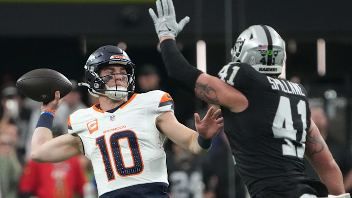 Nov 24, 2024; Paradise, Nevada, USA; Denver Broncos quarterback Bo Nix (10) throws the ball against Las Vegas Raiders linebacker Robert Spillane (41) in the first quarter at Allegiant Stadium. 