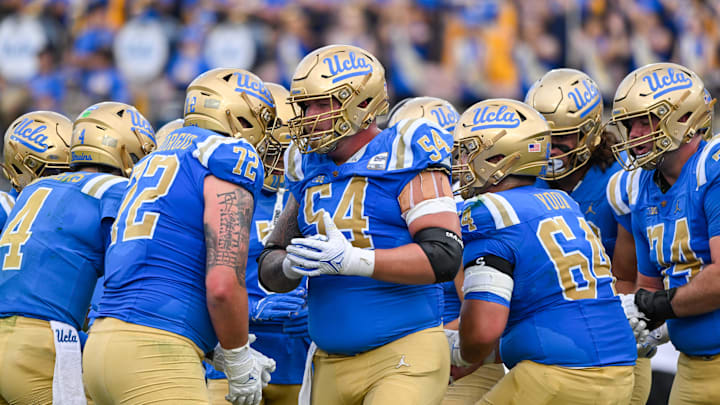 Nov 30, 2024; Pasadena, California, USA; UCLA Bruins offensive lineman Josh Carlin (54) in the huddle during the second quarter against the Fresno State Bulldogs at Rose Bowl. Mandatory Credit: Robert Hanashiro-Imagn Images