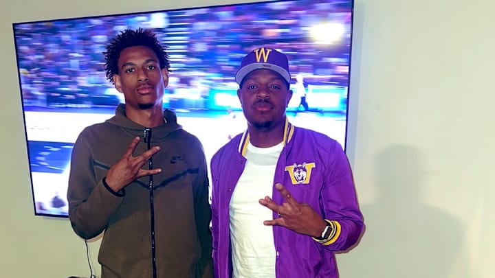 Recruit Justin Lewis and UW secondary coach John Richardson pose on a visit. 