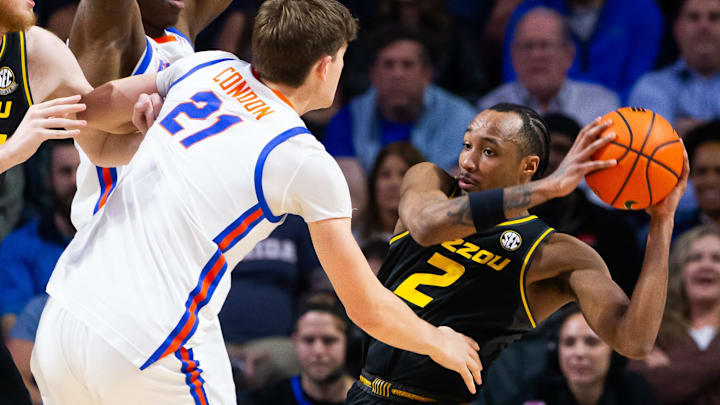 Florida Gators forward Alex Condon (21) pressures Missouri Tigers guard Tamar Bates (2) during the first half. The Florida men   s basketball team hosted the Missouri Tigers at Exactech Arena at the Stephen C. O   Connell Center in Gainesville, FL on Wednesday, February 28, 2024. [Doug Engle/Ocala Star Banner]