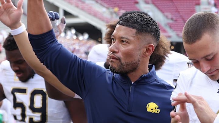 Sep 27, 2025; Fayetteville, Arkansas, USA; Notre Dame Fighting Irish head coach Marcus Freeman leads the team in celebration after the game against the Arkansas Razorbacks at Donald W. Reynolds Razorback Stadium. Notre Dame won 56-13. Mandatory Credit: Nelson Chenault-Imagn Images